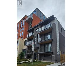 A modern apartment building with a no parking sign in front.