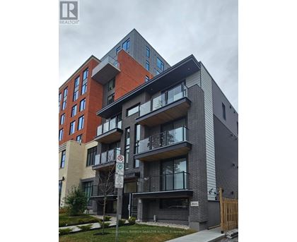 A modern apartment building with a no parking sign in front.