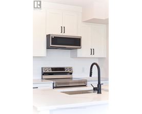 A modern kitchen with a microwave above the stove.
