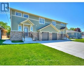 A house with a blue and yellow exterior is for sale through REVEL Realty Inc.