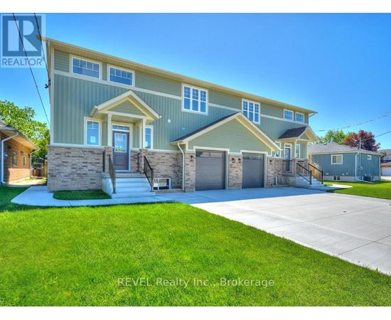 A house with a blue and yellow exterior is for sale through REVEL Realty Inc.
