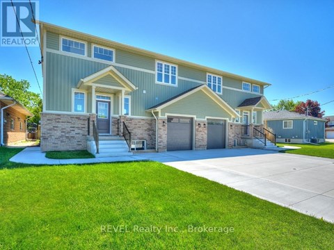 A house with a blue and yellow exterior is for sale through REVEL Realty Inc.