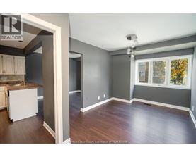 A spacious room with a window and a sink.