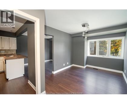 A spacious room with a window and a sink.