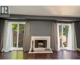 A living room with a fireplace and curtains.