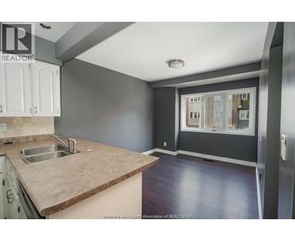 A kitchen with a sink and a window.