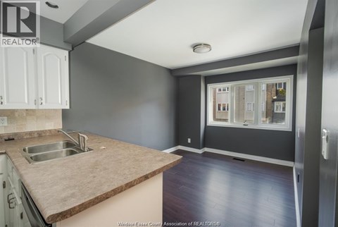 A kitchen with a sink and a window.