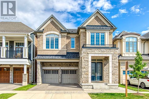 A large, two-story house with a stone facade and a balcony on the second floor.