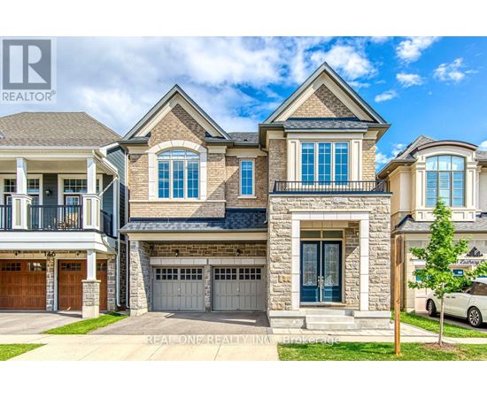 A large, multi-story house with a stone facade and a garage door.
