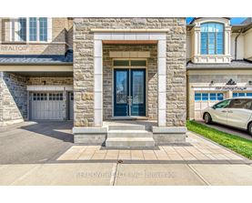 A stone house with a car parked in front.