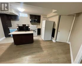 A kitchen with a white fridge and a white oven.