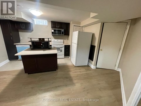 A kitchen with a white fridge and a white oven.