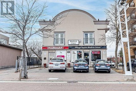 A medical clinic with a pharmacy is located in a commercial area.