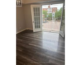 A room with a sliding door and wooden flooring.