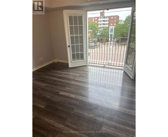 A room with a sliding door and wooden flooring.