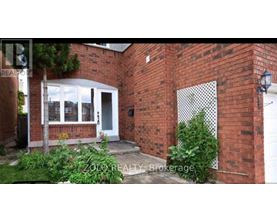 A brick house with a white door and windows.