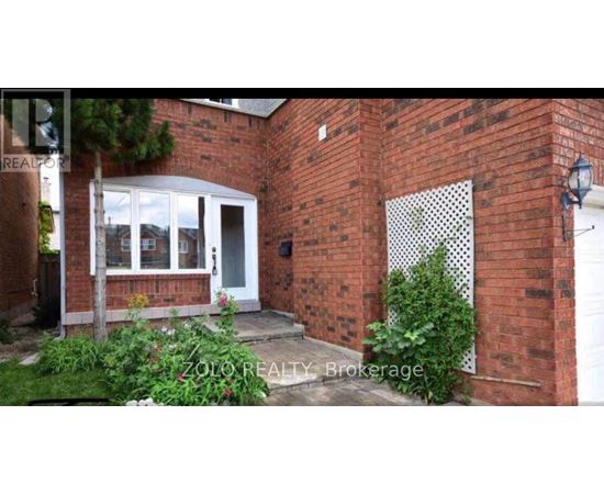 A brick house with a white door and windows.