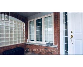 A window with a white frame and a black bench in front of it.