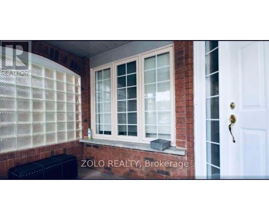 A window with a white frame and a black bench in front of it.