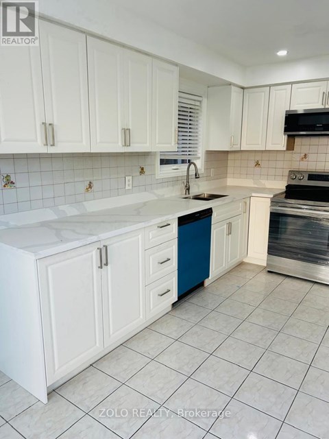 A kitchen with white cabinets and a blue drawer.