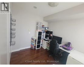 A room with a desk, chair, and shelves.