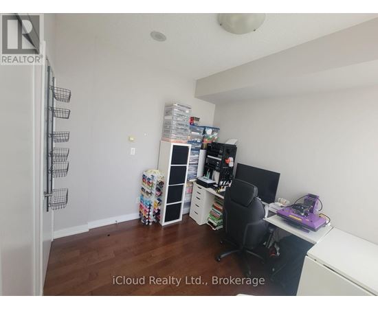 A room with a desk, chair, and shelves.