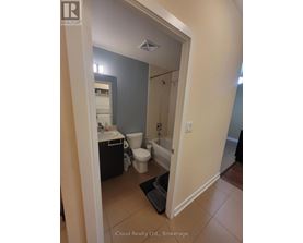 A bathroom with a toilet, sink, and shower.