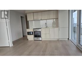 A kitchen with white appliances and wooden cabinets.