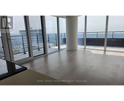 A room with a view of the cityscape from a high-rise building.