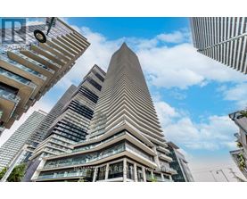 A tall building with a triangular top is the focal point of the image.