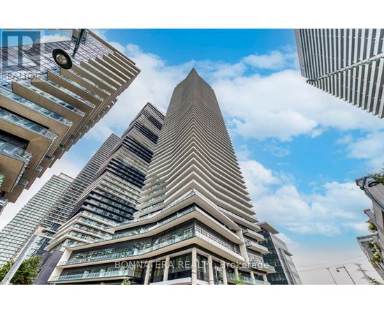 A tall building with a triangular top is the focal point of the image.