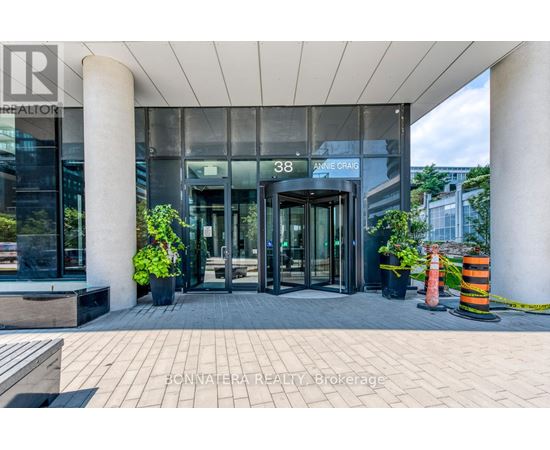 The entrance to a building with a glass door and a sign that reads "38 ARNIE GRAHAM".