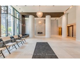 A reception area with white pillars and chairs.