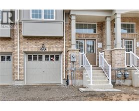 A house with a garage and a staircase leading to the entrance.