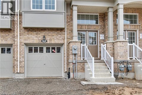 A house with a garage and a staircase leading to the entrance.