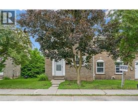 A house with a tree in front and a sign that says "Reserved".