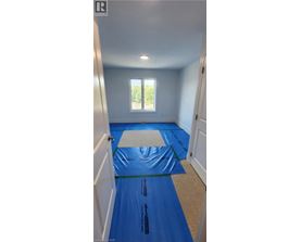A room with a blue tarp on the floor.