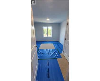 A room with a blue tarp on the floor.