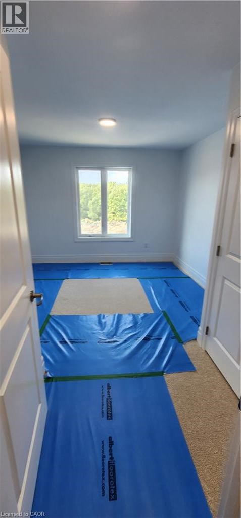 A room with a blue tarp on the floor.