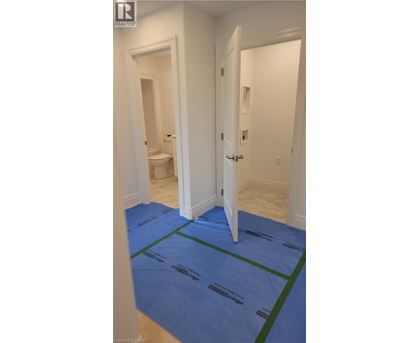 A room with a blue carpet and a white door.