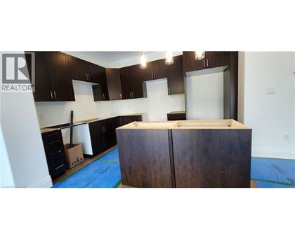 A kitchen with dark wood cabinets and a white counter top.