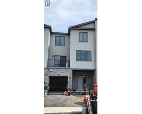 A two-story residential building with a garage door and a balcony.