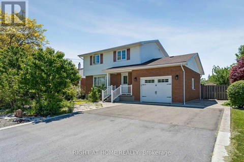 A two-story house with a garage is for sale.