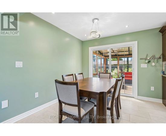 A dining room with a table and chairs.