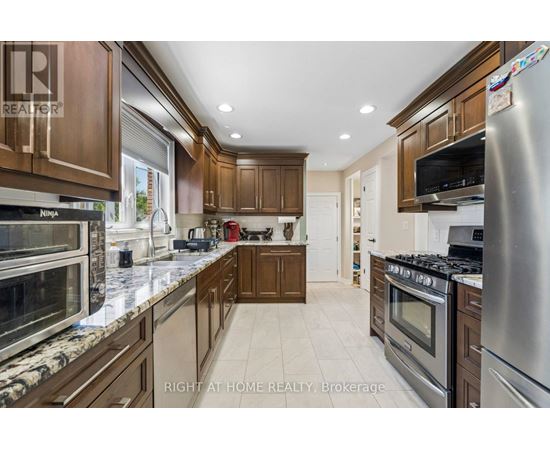 A kitchen with wooden cabinets and stainless steel appliances.