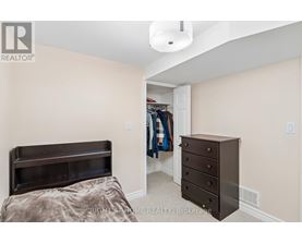 A bedroom with a bed, dresser and a closet.