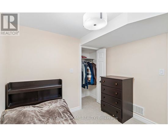 A bedroom with a bed, dresser and a closet.