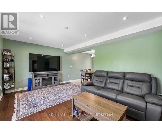 A living room with a grey leather couch and a wooden coffee table.
