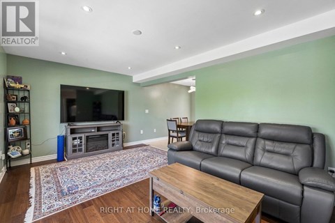 A living room with a grey leather couch and a wooden coffee table.