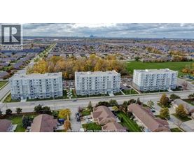 A realtor photo of a residential area with apartment buildings and houses.
